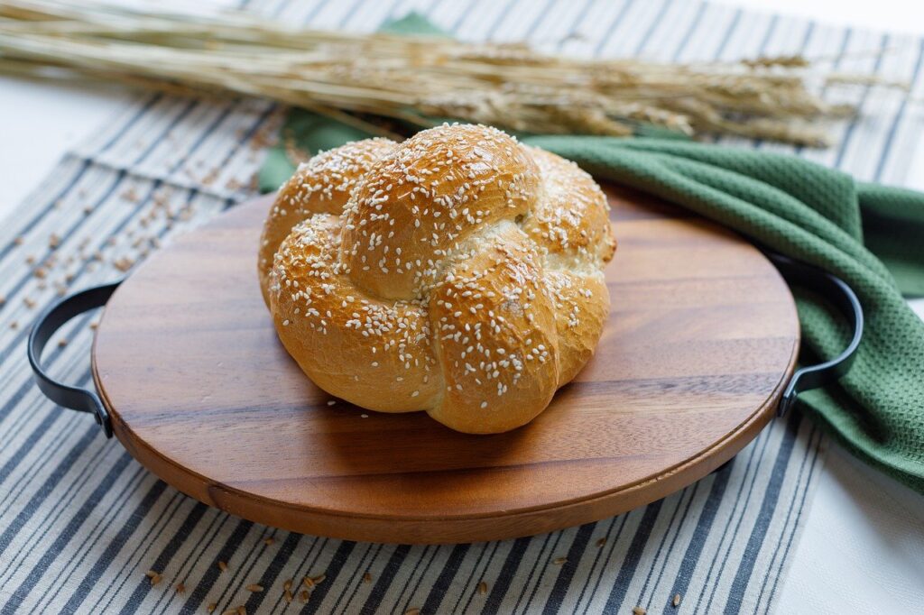 a light colored small round challah sitting on a table