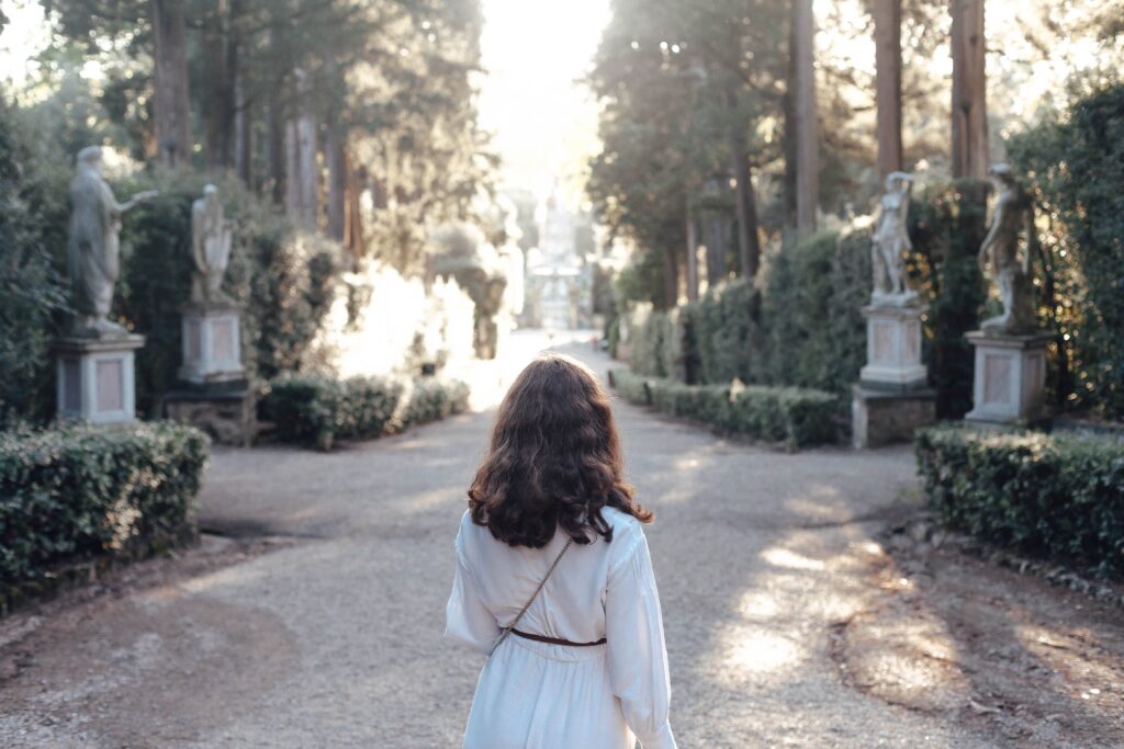 teenaged girl facing a sculpture garden in Florence, Italy