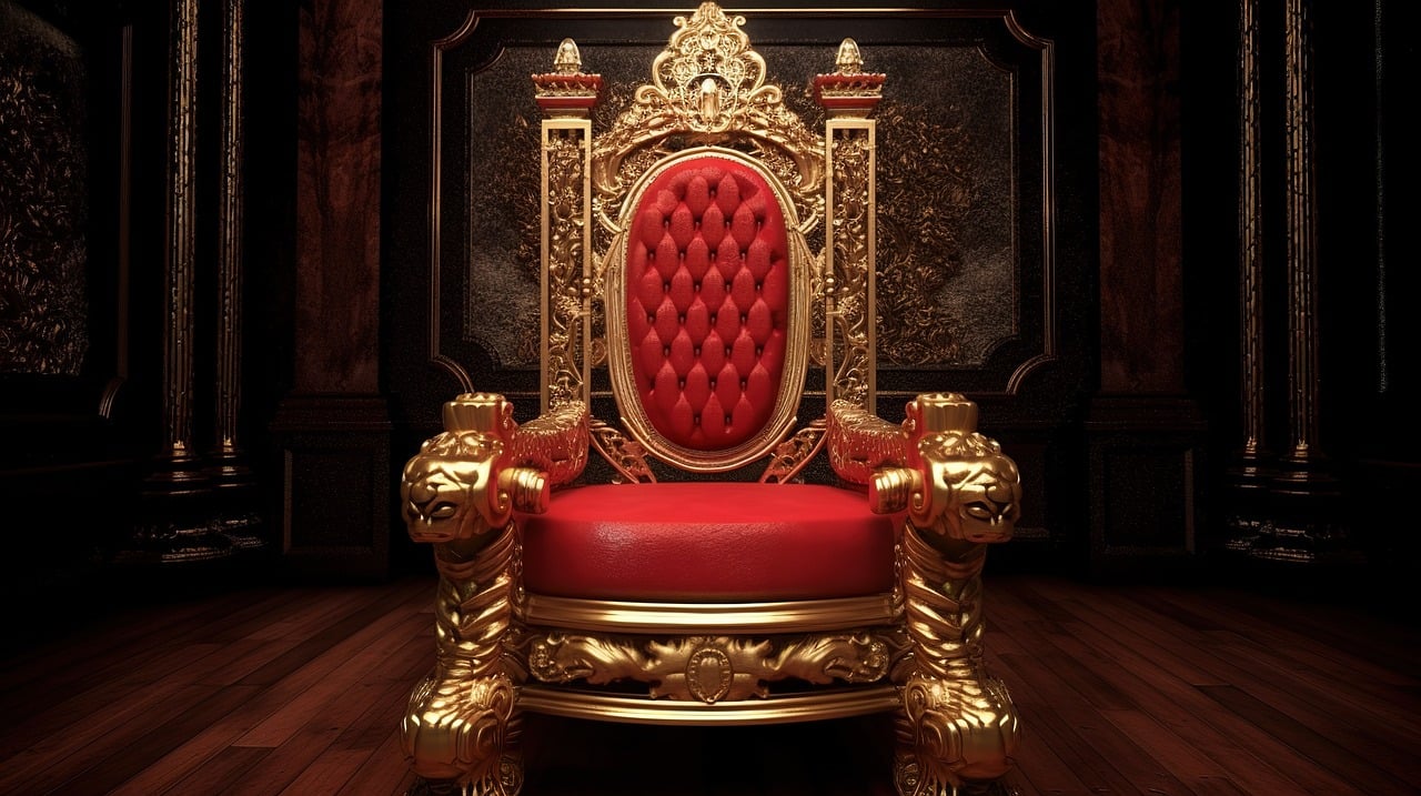 a throne with red cushions and ornate gold trim