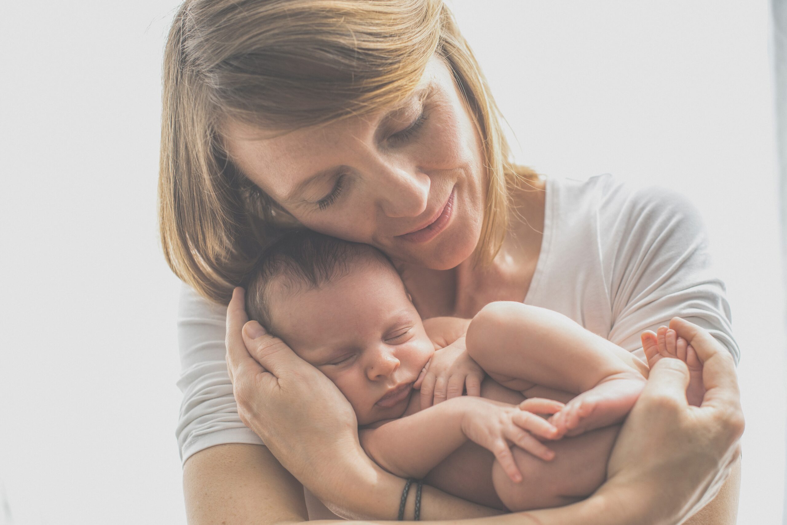 mother snuggling baby