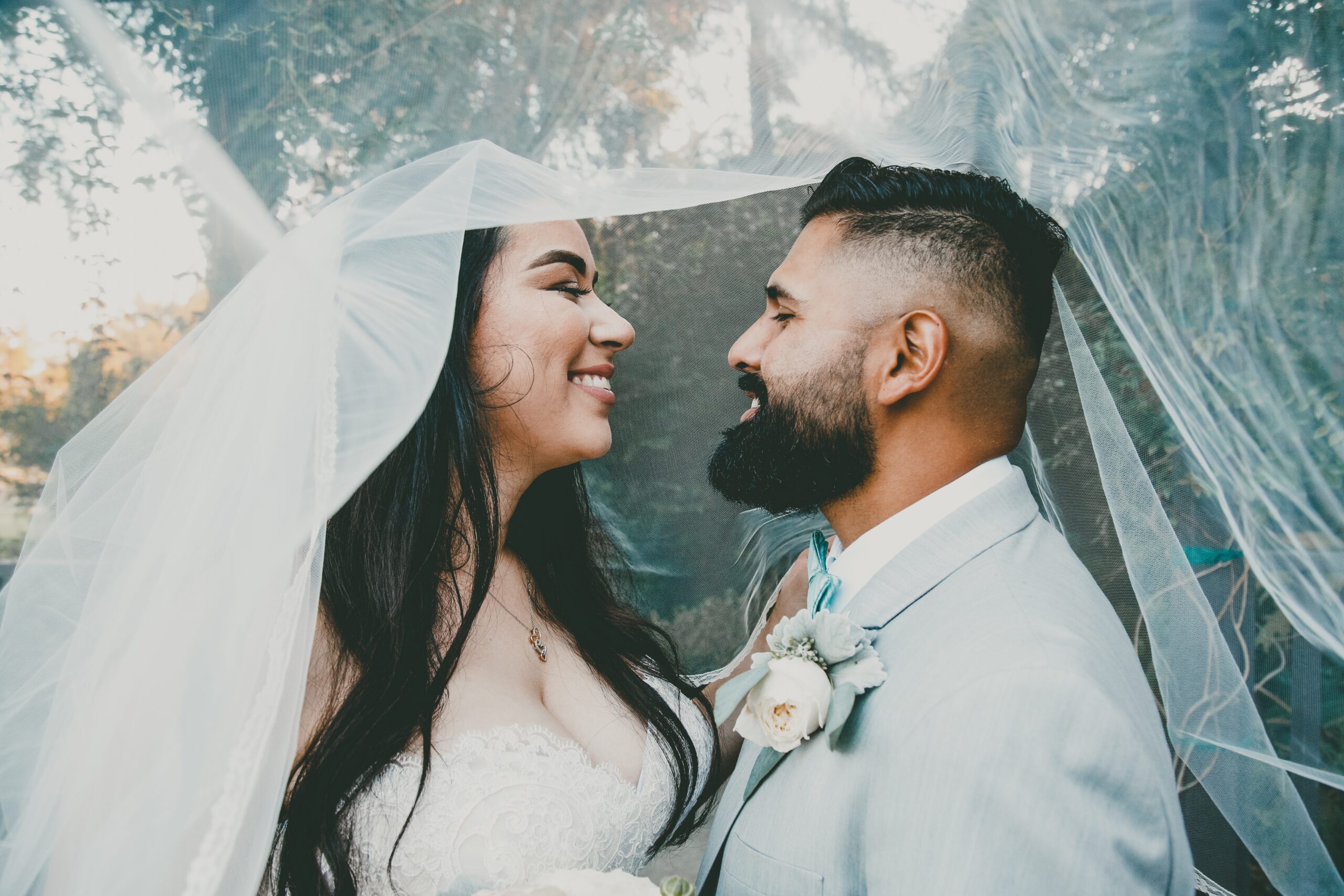 bride and groom under canopy