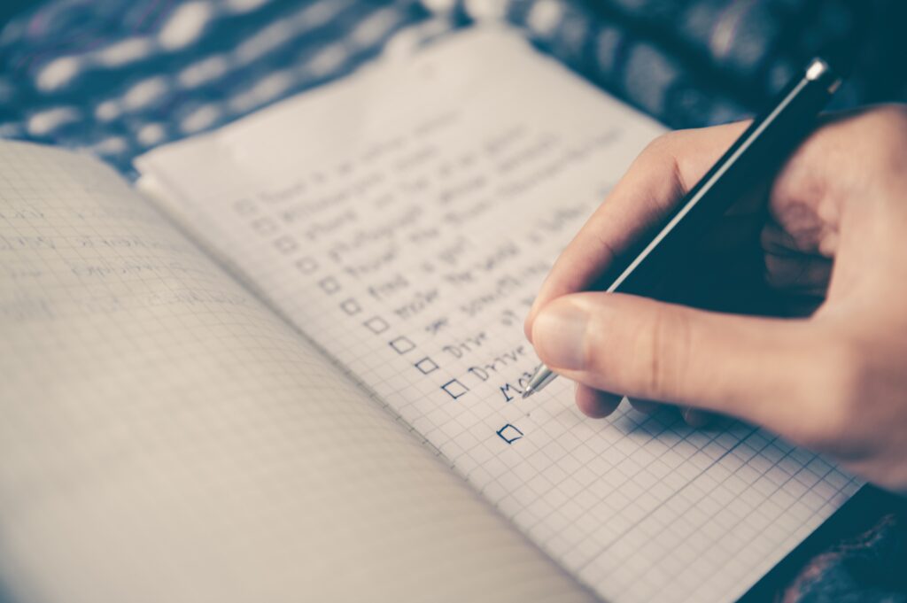 person checking off items on to do list