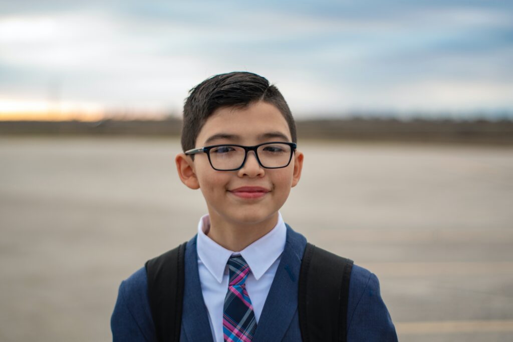 teenaged boy in cardigan, dress shirt, and tie