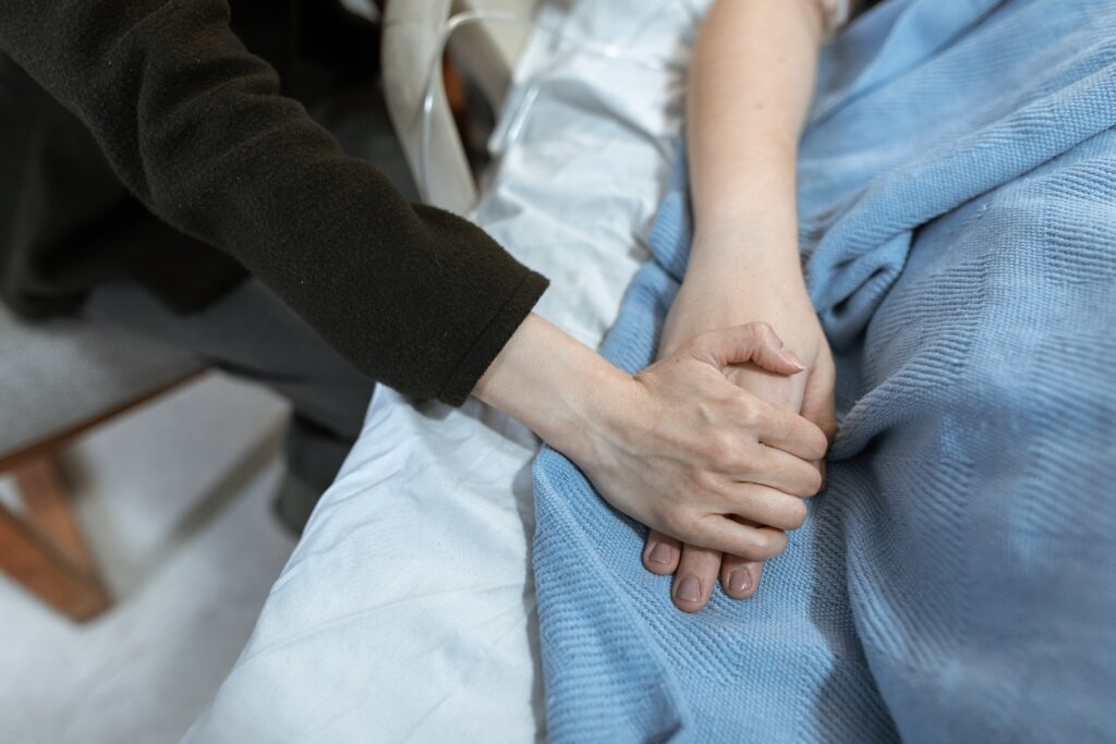 holding hands hospital bed