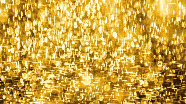 Golden bokeh lights create a shimmering, abstract background.