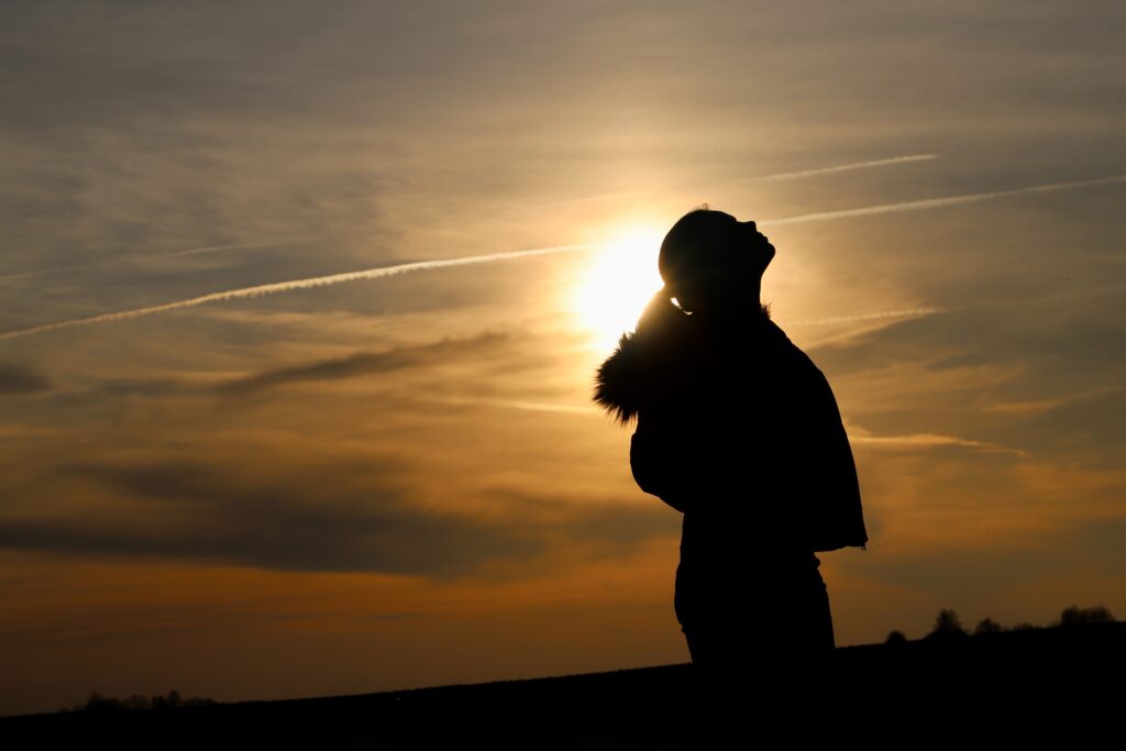woman in silhouette against sunset