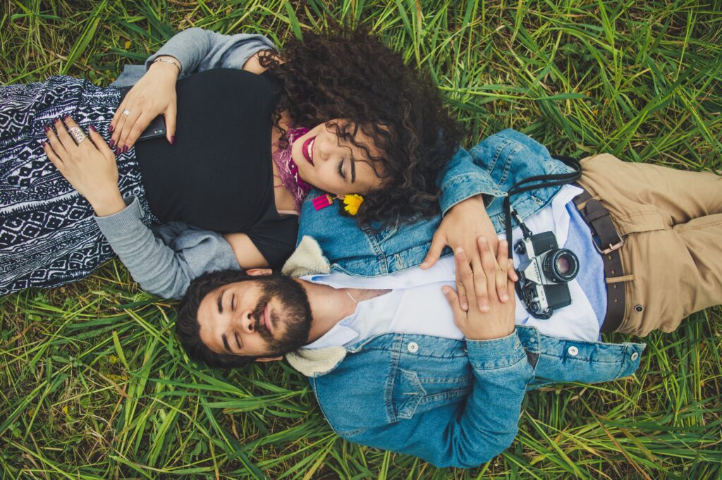 young couple lying in the grass