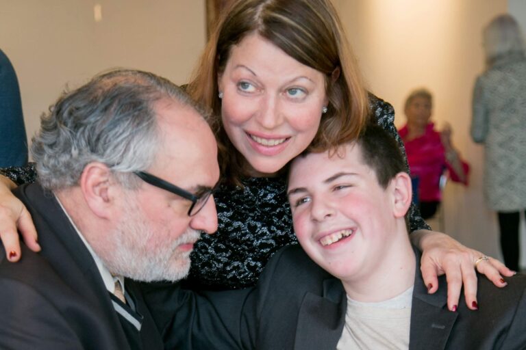 George, the Bar Mitzvah boy, smiles with his parents.