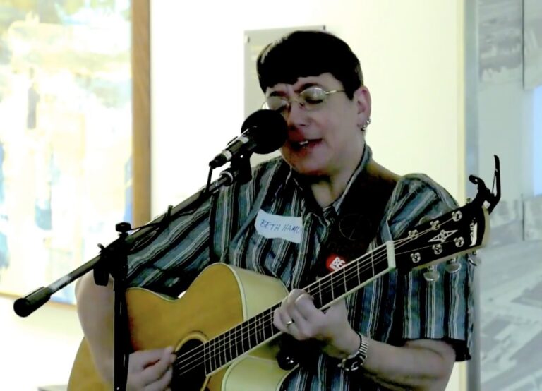 Screenshot of the author singing into a mic with a guitar