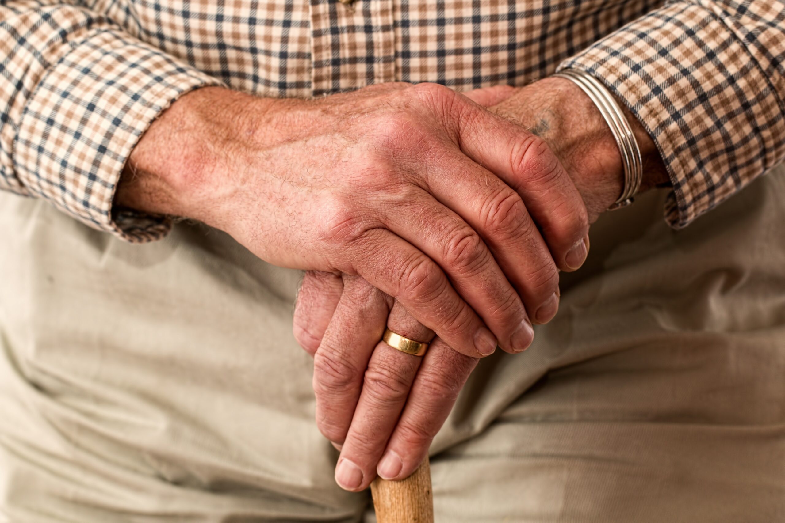 mans hands holding cane