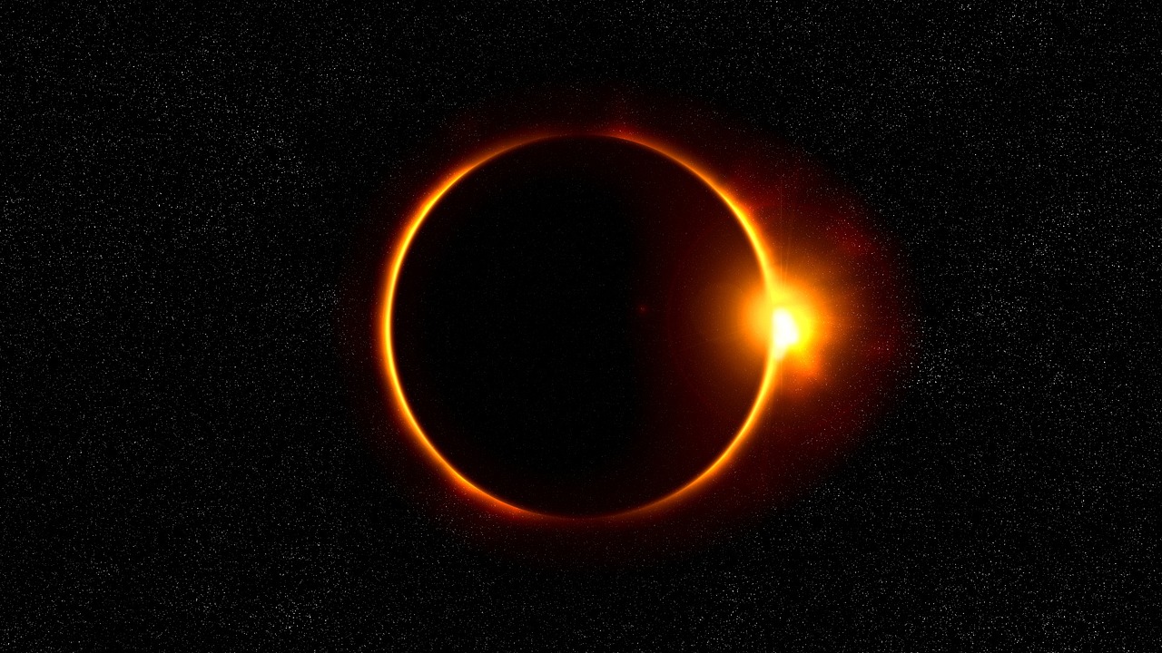 a solar eclipse sun flare against a black sky