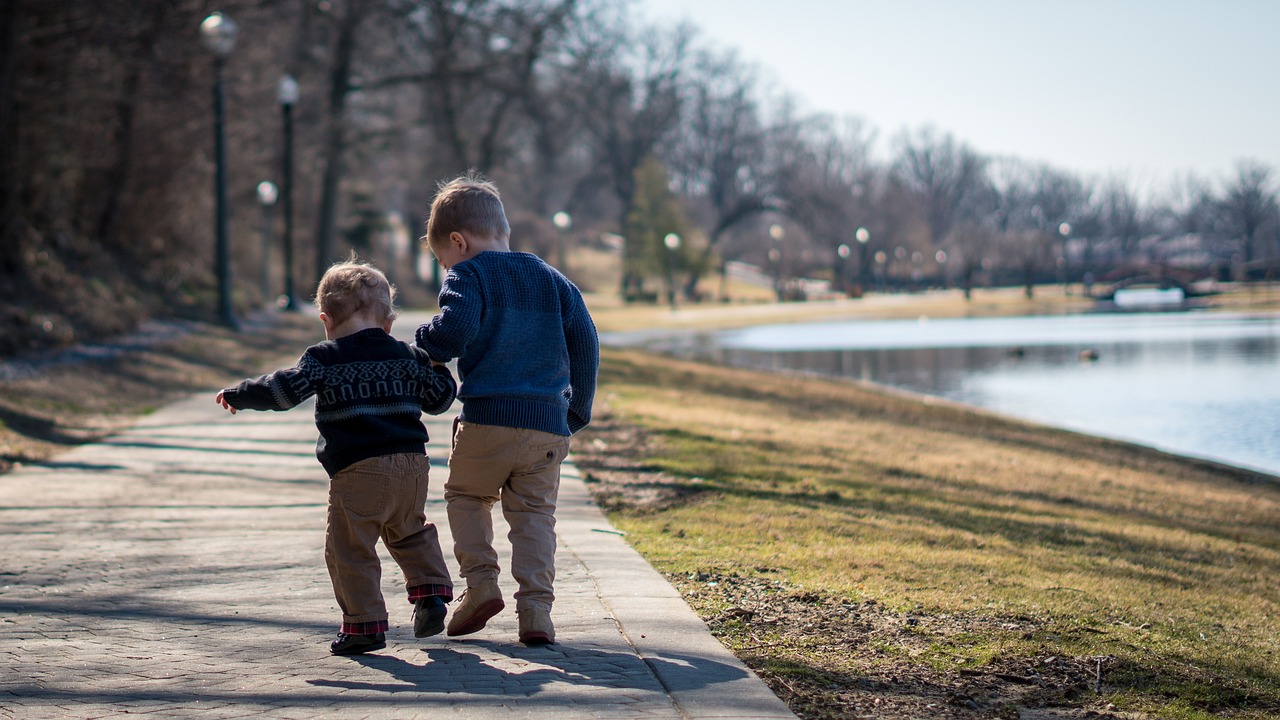 two children walk hand in hand