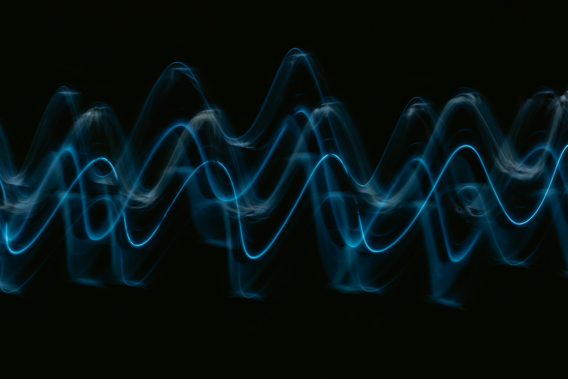 thin blue waves against a dark background