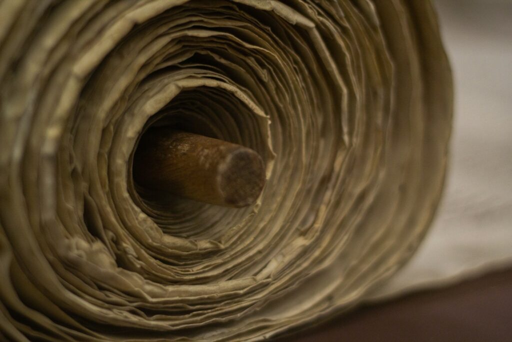 a large scroll wrapped around a wooden pole