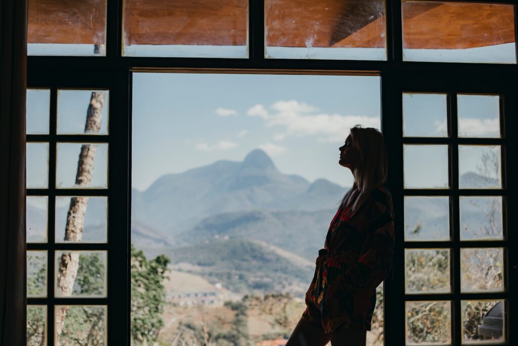 woman silhouetted in a window with a desert landscape behind her