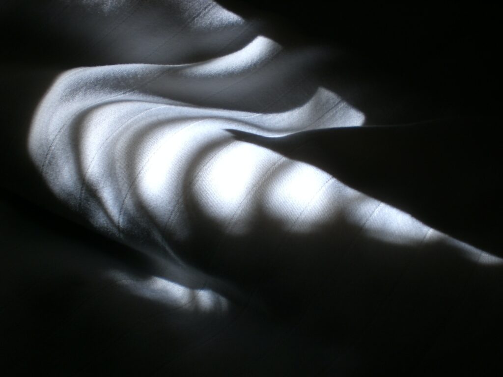 folded white fabric in shadows