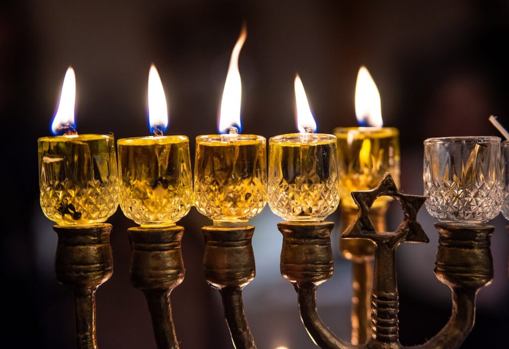 a close up of candles burning in a menorah