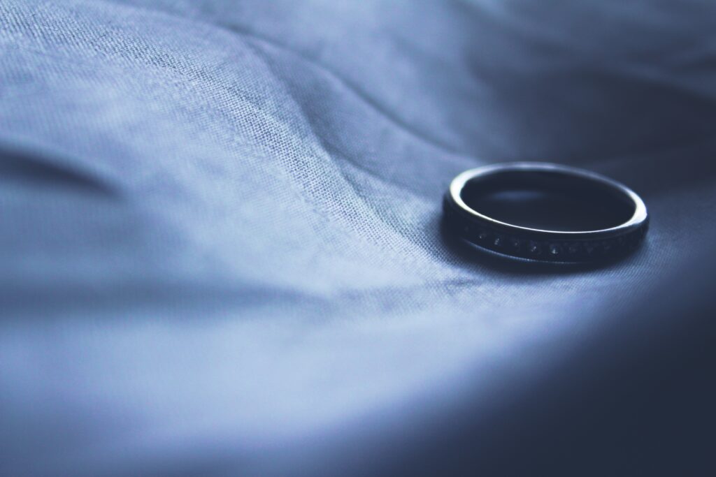 wedding band on a piece of blue fabric