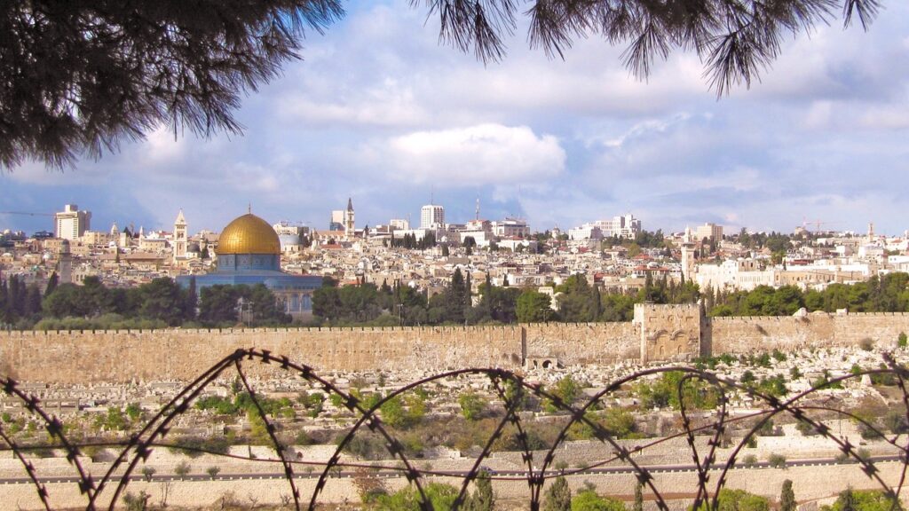 shot of Jerusalem on a sunny day with barbed wire in the foreground