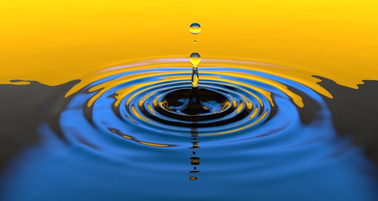 drops of water come down onto a surface of water, creating a circular ripple