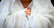 a person wearing a white tallit