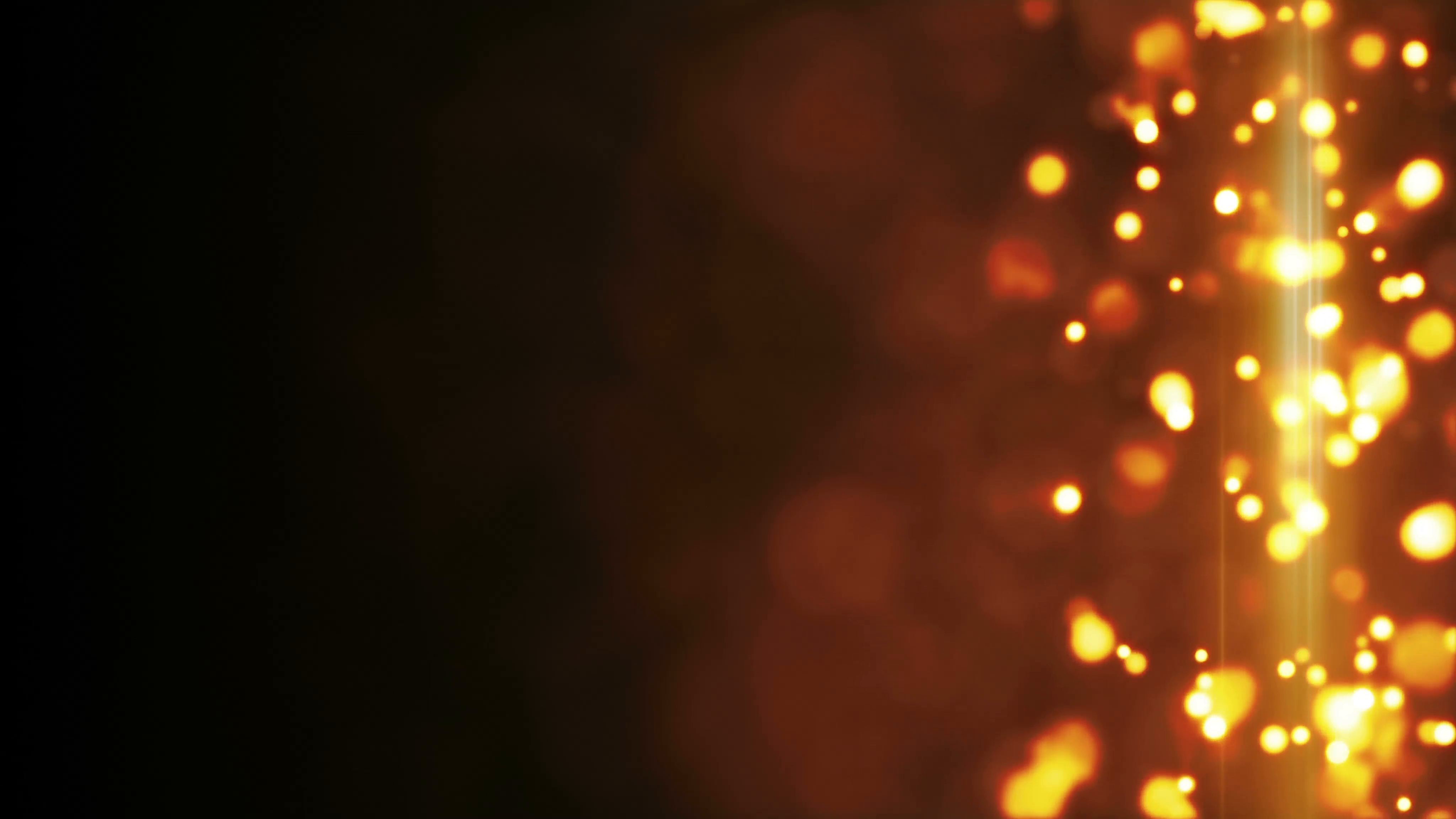 Warm orange bokeh lights on a dark background, creating an abstract and glowing atmosphere.