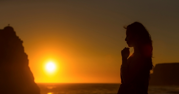 a person in silhoutte against the sunset