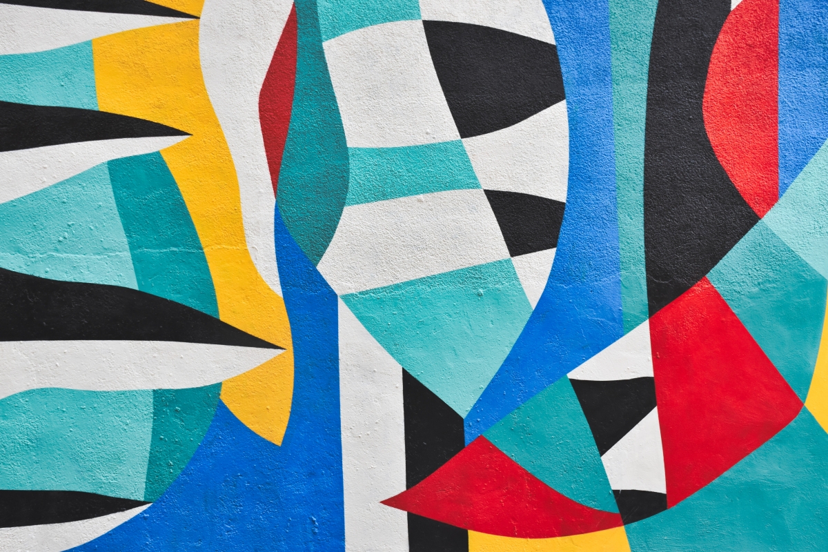 Colorful abstract mural with bold geometric shapes in red, blue, yellow, black, and white.