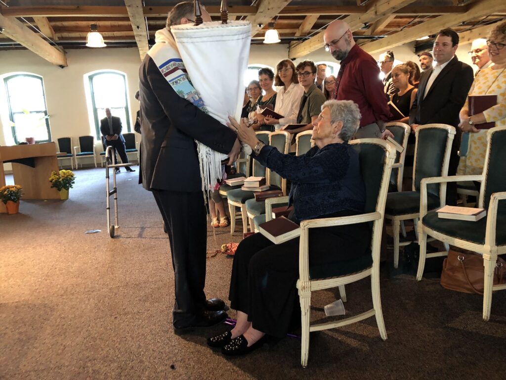 A rabbi bring the Torah to a member of the congregation