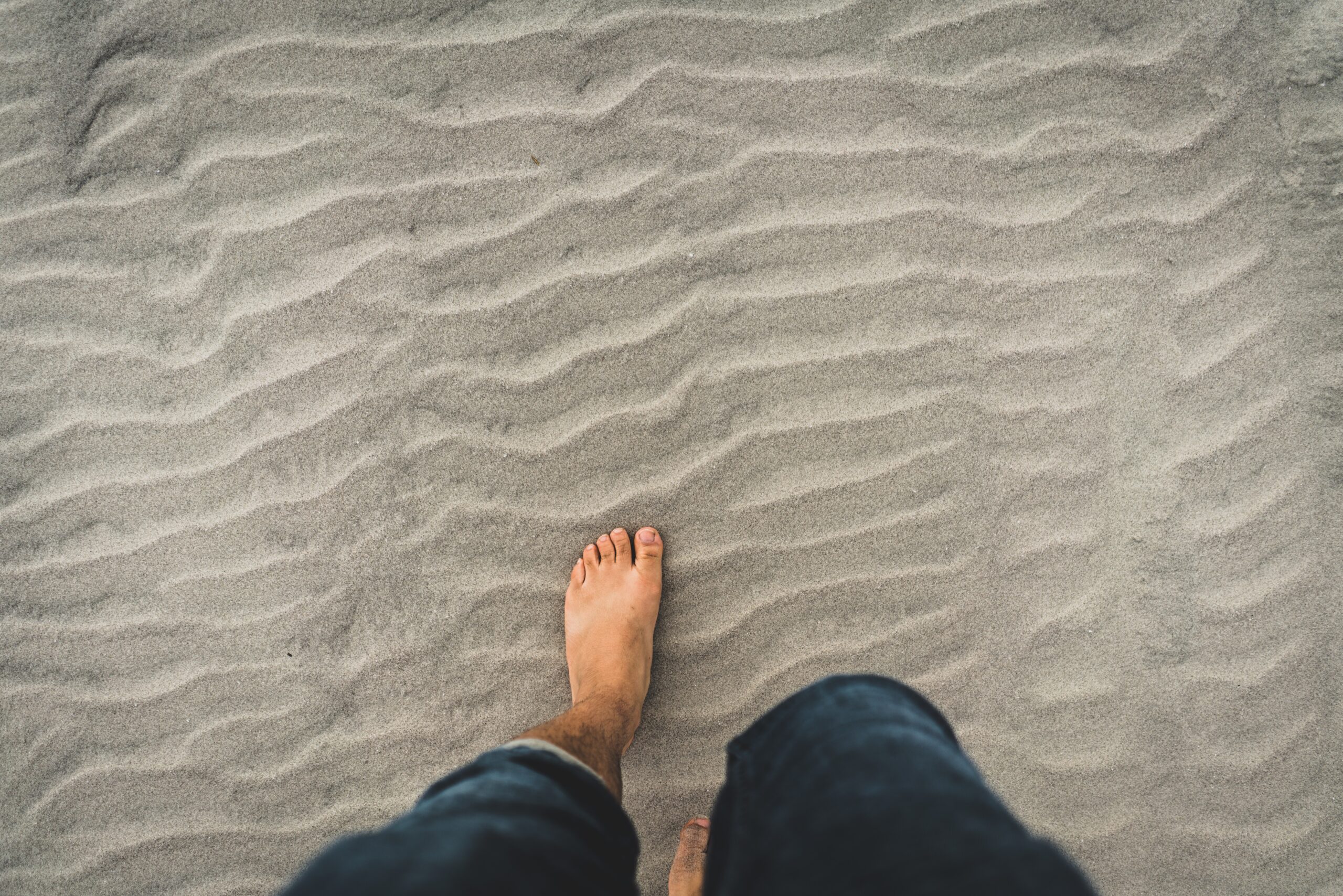bare feet walking in the sand