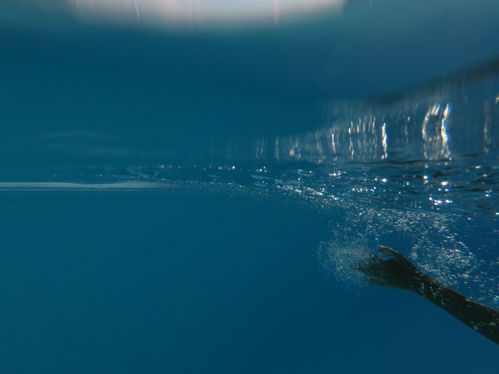 hand underwater in pool