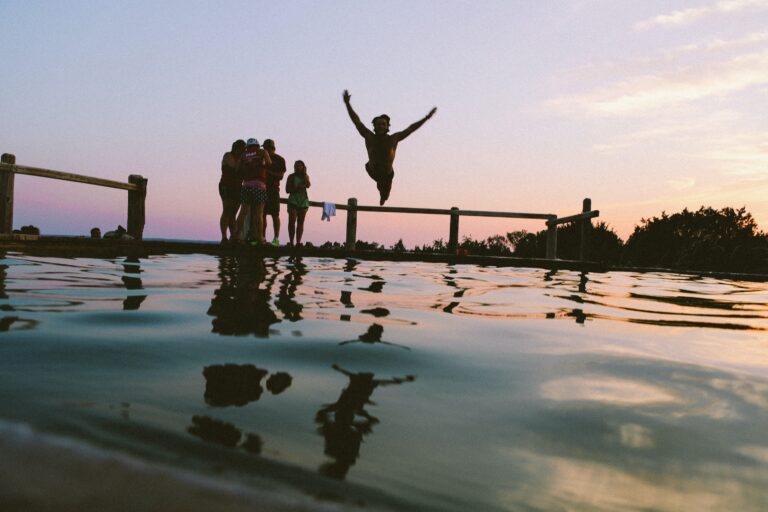 teen jumping into a lake