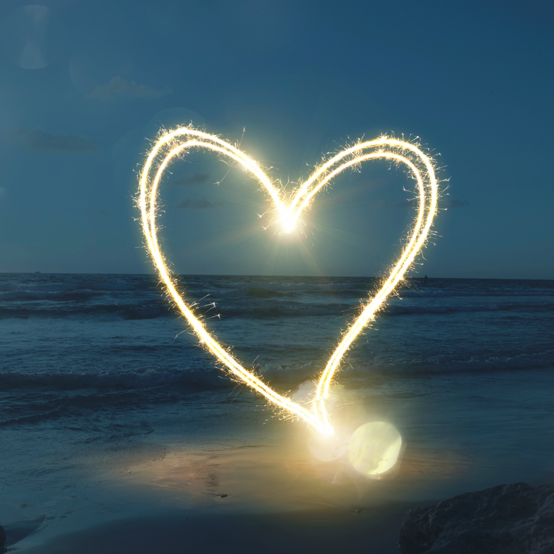 Glowing heart on a beach