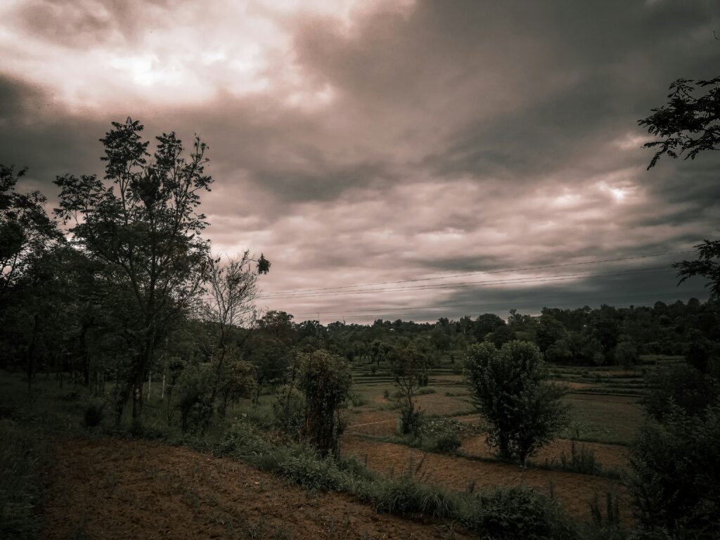 dark clouds hover over the hills