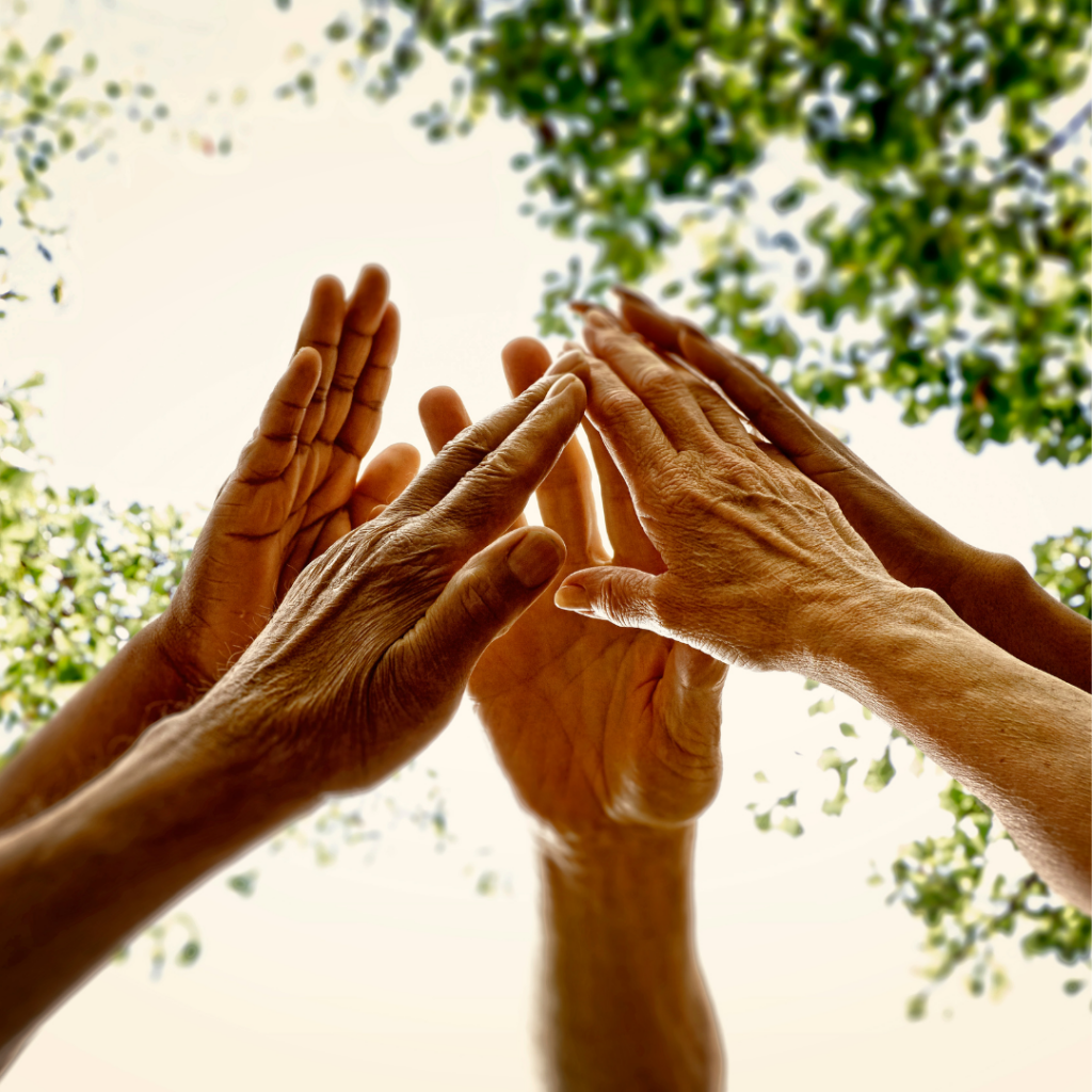 Image of people's hands raised up in a circle almost touching