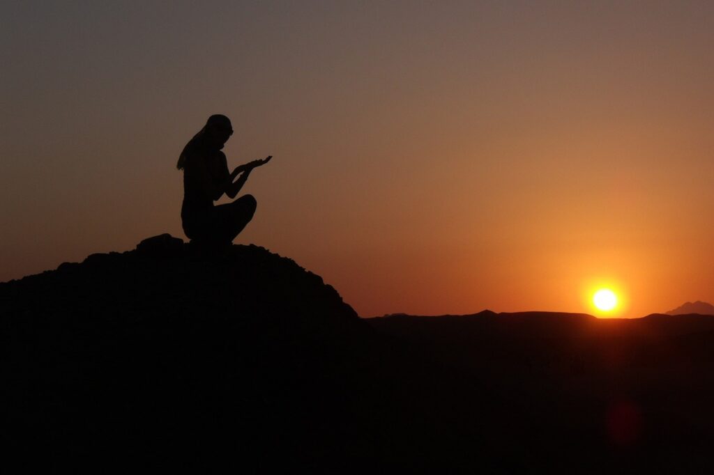 A woman sitting alone in the desert