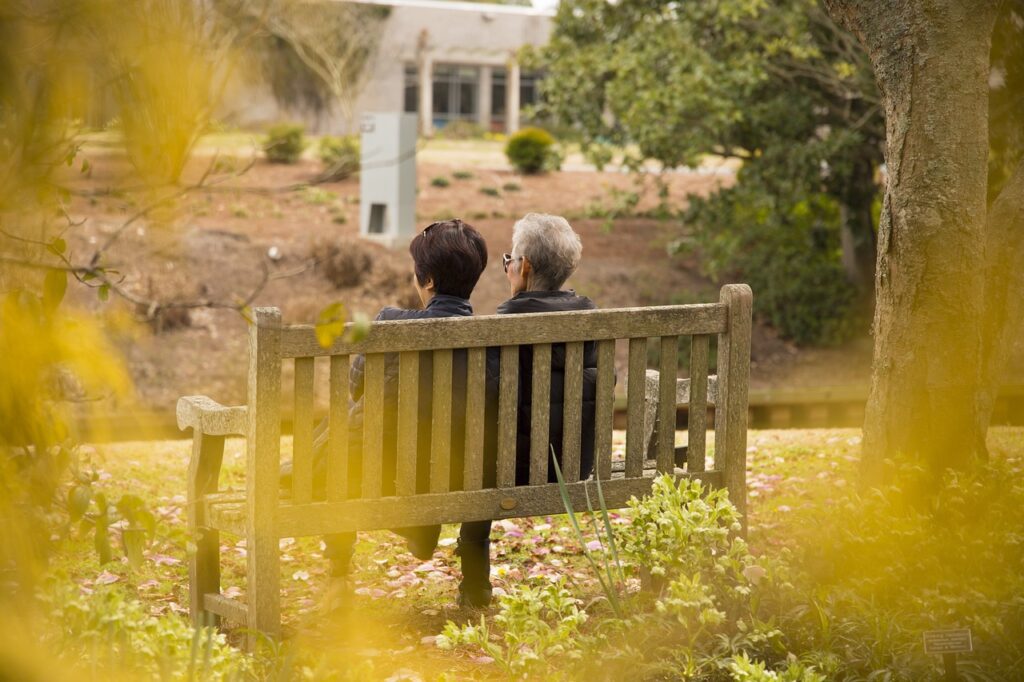 an older woman and family member sitting on a bench