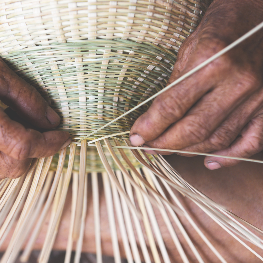 hands weaving a basket
