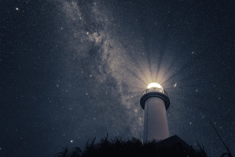 lighthouse against a starry sky