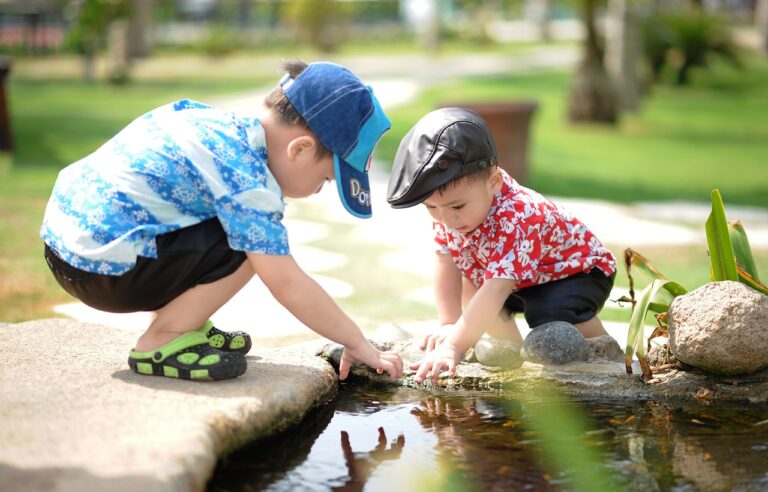 two children playing in a pond