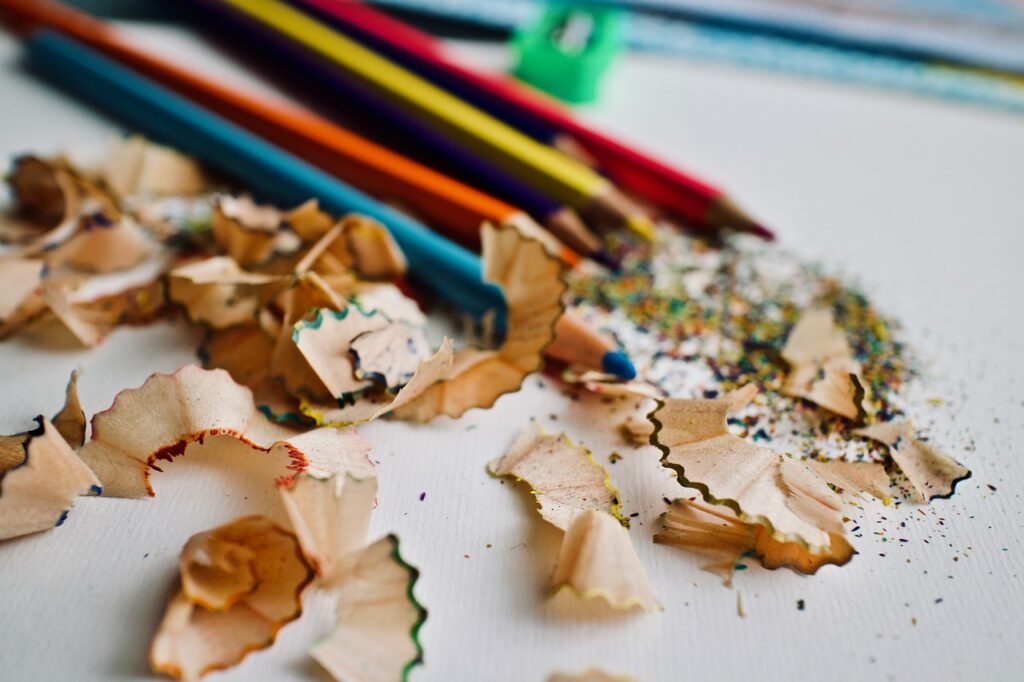 colored pencils and shavings on a piece of papaer