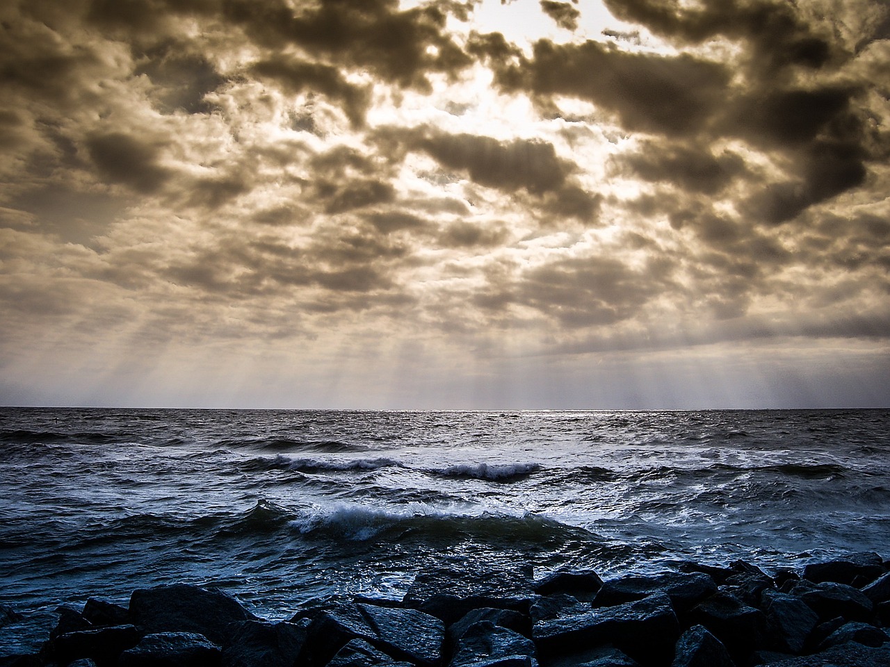 A cloudy sky over rocky shores