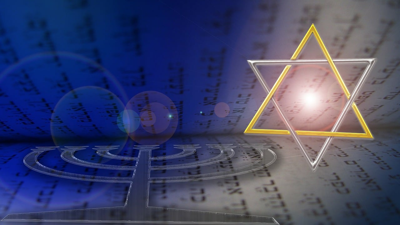 Hebrew letters in a book, covered by a menorah with a star of david shining down