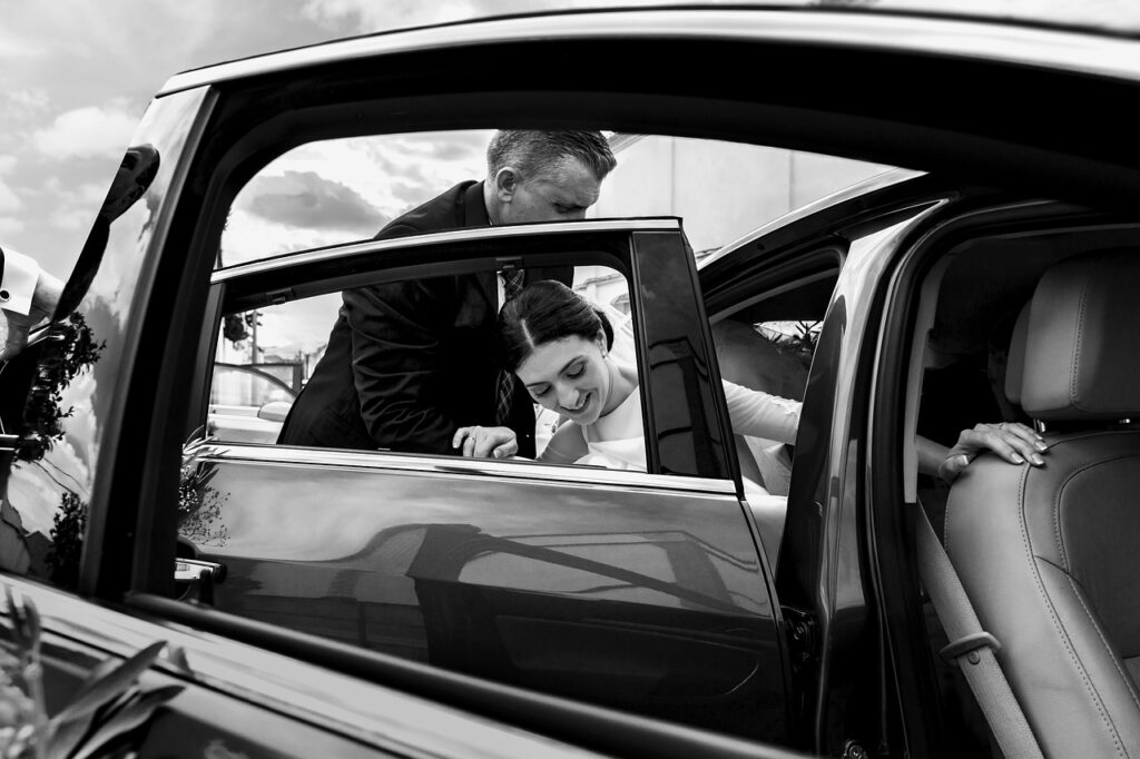 a bride steps out of a car