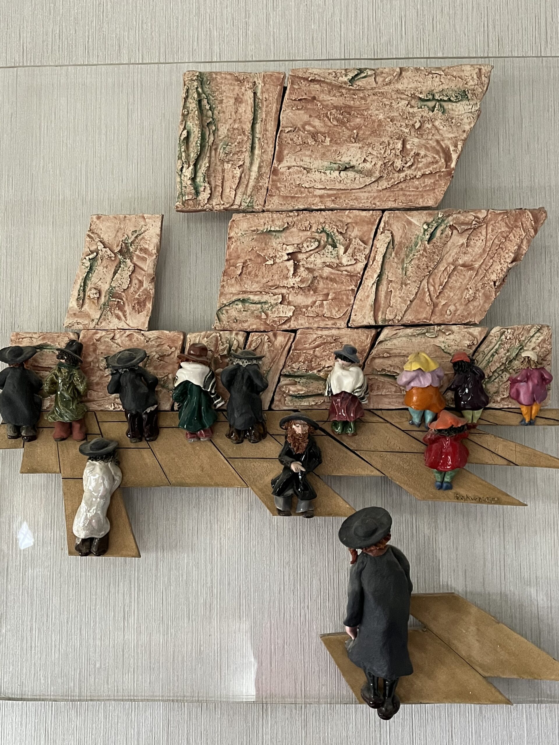 a sculpture of people praying at the Kotel