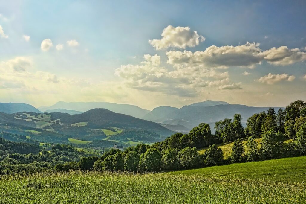 sunlight over green fields and hills