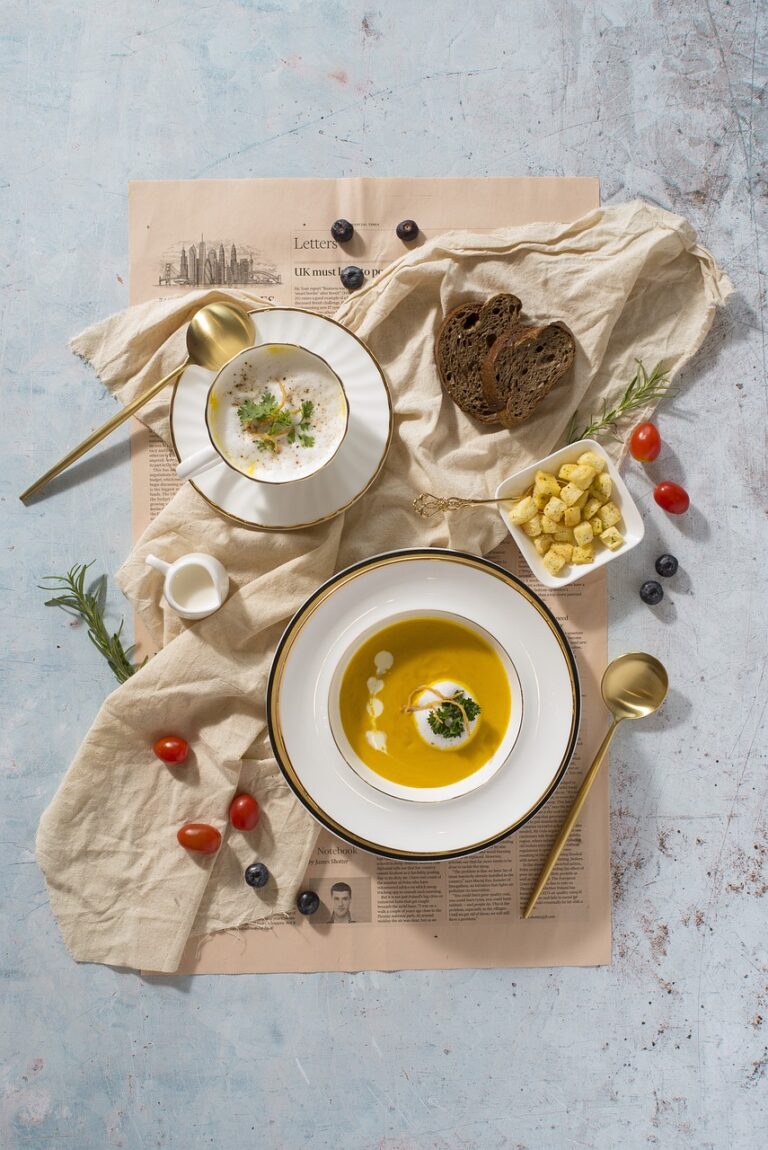 two bowls of soup, bread and soup nuts