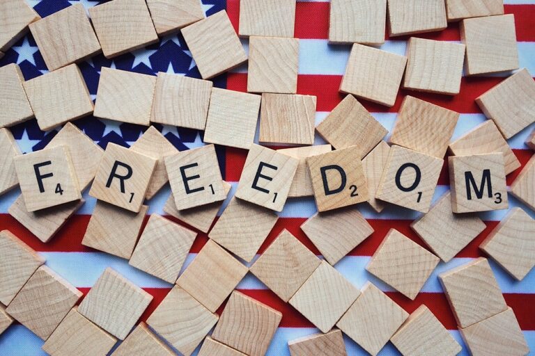 scrabble tile letters spell out freedom