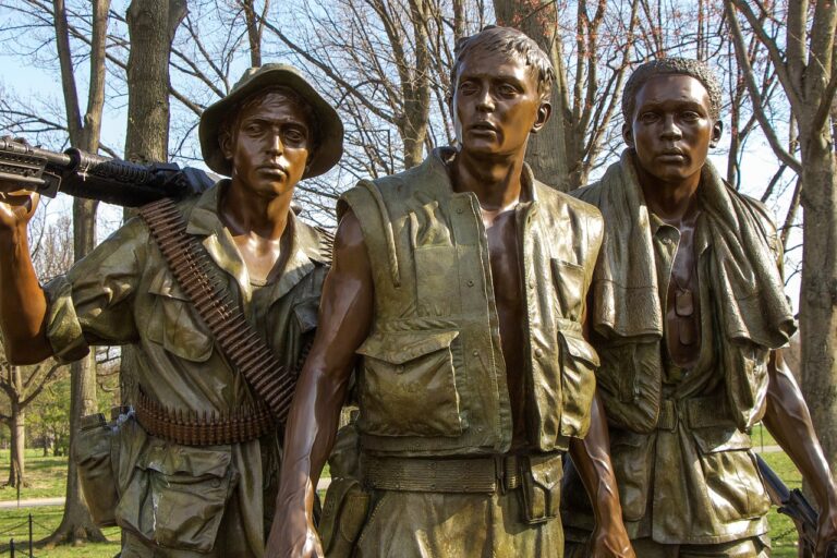 a statue of the Vietnam memorial showing three male soldiers