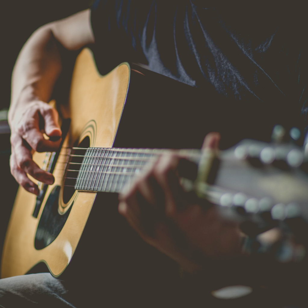 a person strumming the guitar